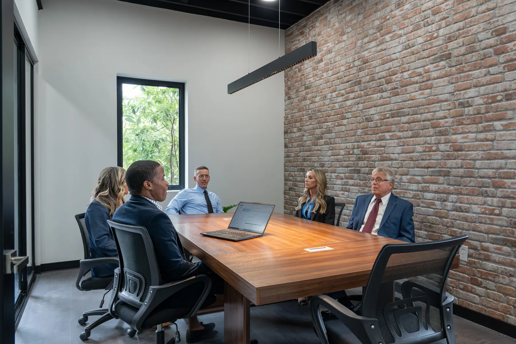 The Cohen Mortgage team meeting in the conference room